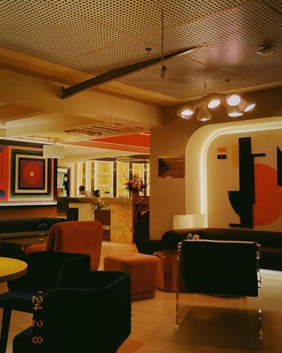 a lobby with couches and tables and chairs at Thien Thai Hotel & Spa in Hanoi