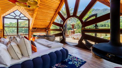 a bedroom with a bed in a room with a window at Extraordinary Barn Loft at Animal Sanctuary in Franschhoek