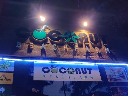a sign for a beach bar at night at Coconut Beach Farm in Alibaug