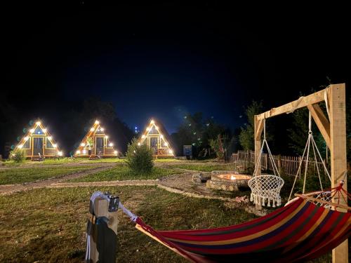 a hammock in a yard at night with lights at Thethi Villas in Theth