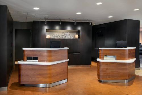a lobby with two counters and a painting on the wall at Courtyard by Marriott San Francisco Airport in San Bruno