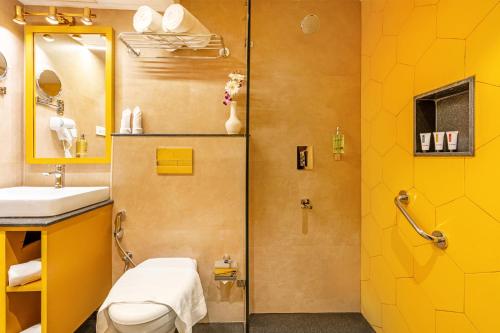 a bathroom with a shower and a toilet and a sink at Sterling Munnar in Munnar