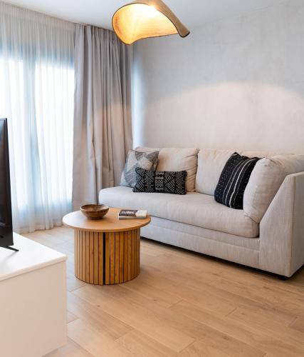 a living room with a couch and a coffee table at Olea Blue in Skiathos Town