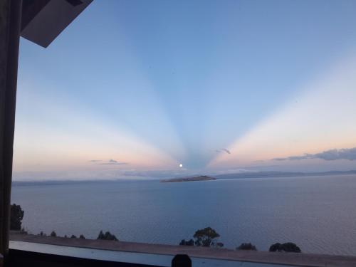 a view of the ocean from a window at Sol y Luna - ISLA DEL SOL in Comunidad Yumani
