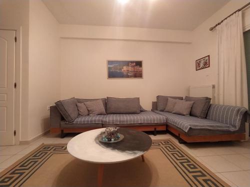 a living room with a couch and a table at The Beach House Gerakini Chalkidiki in Yerakiní