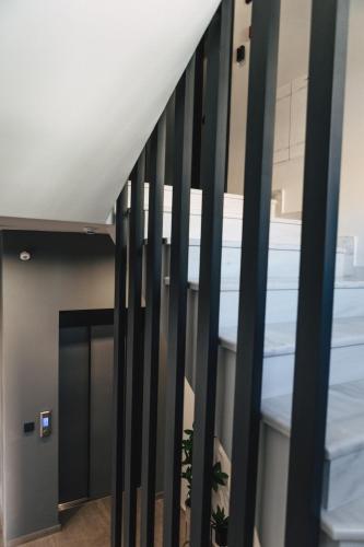 a staircase in a building with black rails at Home Avenue in Alexandroupoli