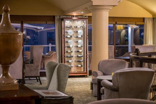 a restaurant with chairs and a wine rack at Beverly Hills in Durban
