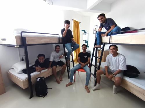 a group of men sitting on bunk beds at IM Santai Lodge in Kangar