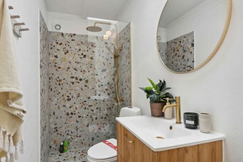 a bathroom with a sink and a shower with a mirror at Seaside Hotel Atmosphere 100 Meters From The Sea in Strøby Egede