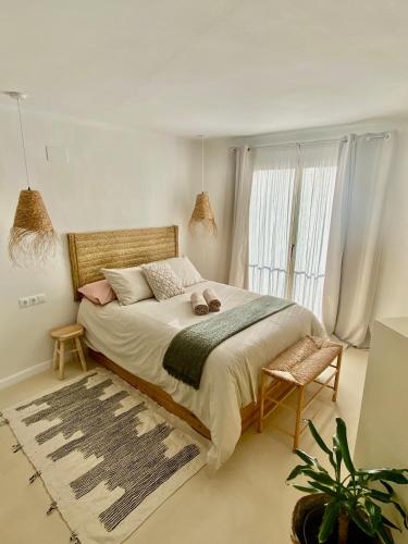 a bedroom with a large bed with a large window at Casa Forta, charm between vines in Capmany
