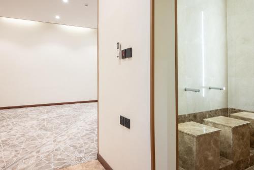 a bathroom with a shower with two sinks at Vender Hotel in Taif