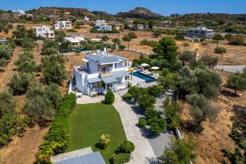 an aerial view of a house with a yard and a pool at Villa Costazia in Kalithies