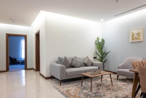 a living room with a couch and a table at Vender Hotel in Taif