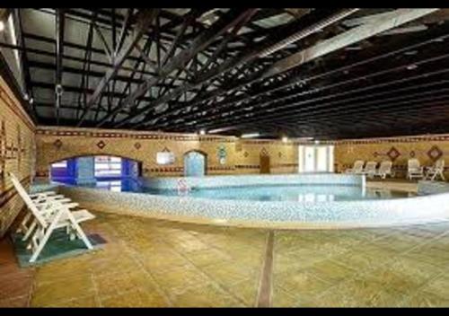 a large swimming pool in a large building with a pool at 11 The Oaks - Lodge - Coghurst Hall - Hastings in Westfield
