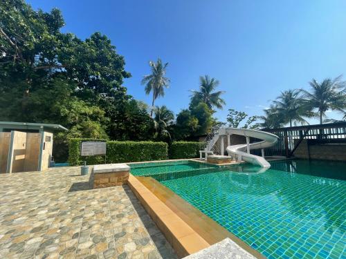 a swimming pool with a slide in a resort at Kai Bae Beach Resort Koh Chang in Ko Chang