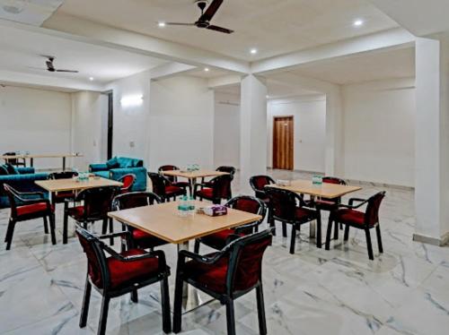 a restaurant with tables and chairs in a room at Akshay dream stay in Gurgaon
