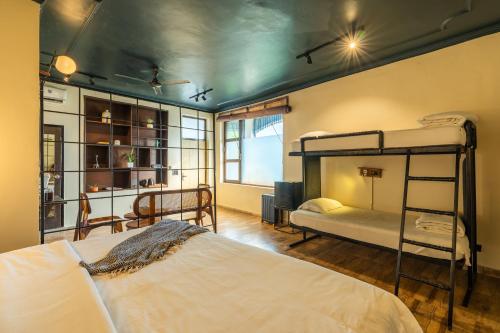 a bedroom with two bunk beds in a room at Minimalist One Hauz Khas Village in New Delhi