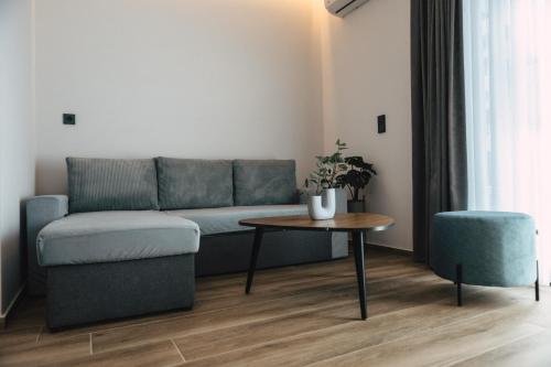 a living room with a couch and a table at Home Avenue in Alexandroupoli