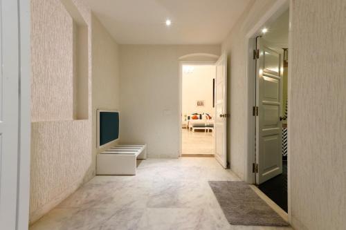 a hallway with a television and a door to a room at Saroja Heritage, Varanasi in Varanasi