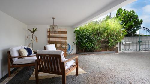 a patio with two chairs and a plant at NostraCasa by LovelyStay in Caniço