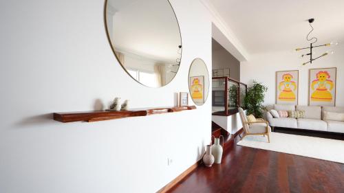 a living room with a mirror and a couch at NostraCasa by LovelyStay in Caniço