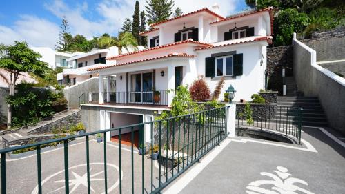 a white house with a staircase in front of it at NostraCasa by LovelyStay in Caniço
