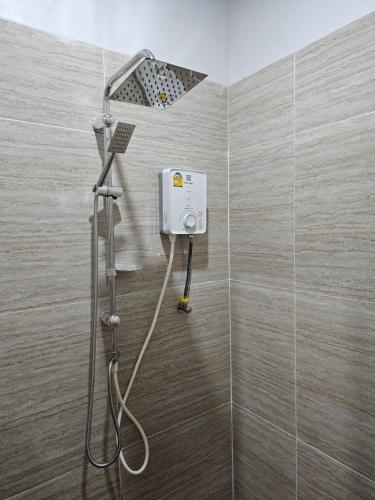 a shower with a shower head in a bathroom at เอเวอร์เมย์ รีสอร์ท Evermay Resort in Ban Plai Khlong