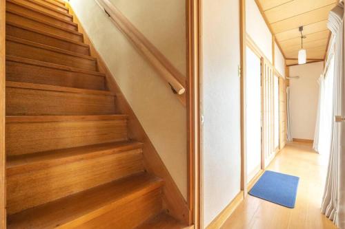 a staircase in a house with a blue rug at Nikko Toyama Forest House in Nikko