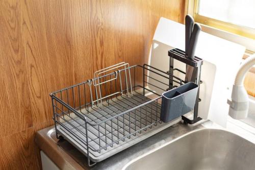 a metal dish drying rack on the side of a sink at Nikko Toyama Forest House in Nikko