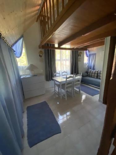 a living room with a table and a couch at Liget Villa Szentendre in Szentendre