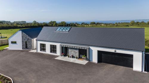 an aerial view of a house with a garage at Lough View in Aldergrove