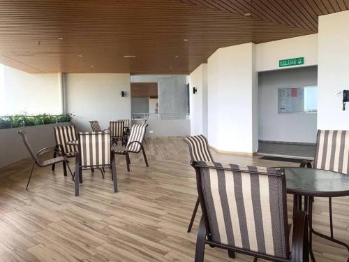 a waiting room with chairs and a table in a building at The Atlantis Residence, 1-5pax in Tranquerah