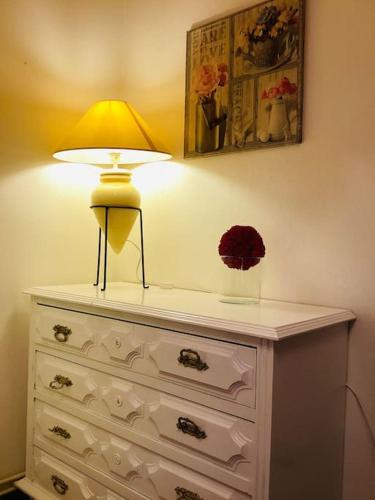 a table with a lamp on top of a dresser at Casa Glória in Cabeceiras de Basto