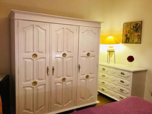 a bedroom with a large white cabinet and a dresser at Casa Glória in Cabeceiras de Basto