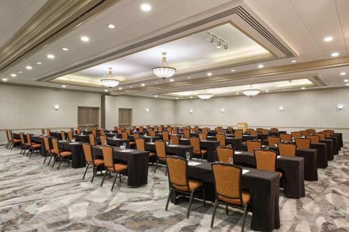 a large room with rows of tables and chairs at DoubleTree by Hilton Minneapolis Airport, MN in Bloomington