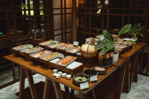 a buffet of food on a wooden table at The Westin Goa in Vagator