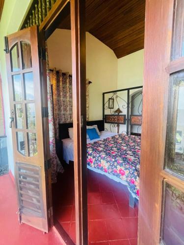 an open door to a bedroom with a bed at Wilson Bungalow Kandy in Kandy