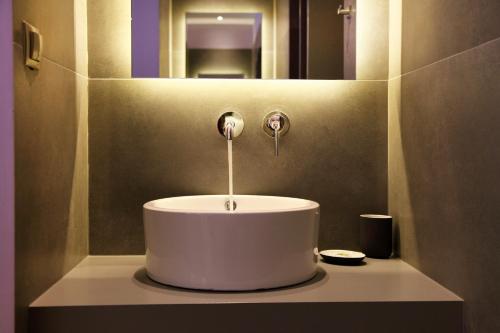 a white sink in a bathroom with a mirror at My Athens House in Athens