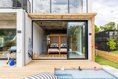 a small house with a pool in the backyard at SALT Luxury Guest Suite Plett in Plettenberg Bay