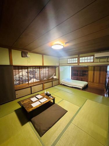 a room with a bed and a table in it at 貸切御宿Villa EL 5 Nikko Kinugawa Area in Nikko