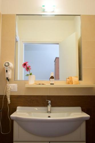 a bathroom with a sink and a mirror at Agriturismo Monte Del Re in San Pietro al Natisone