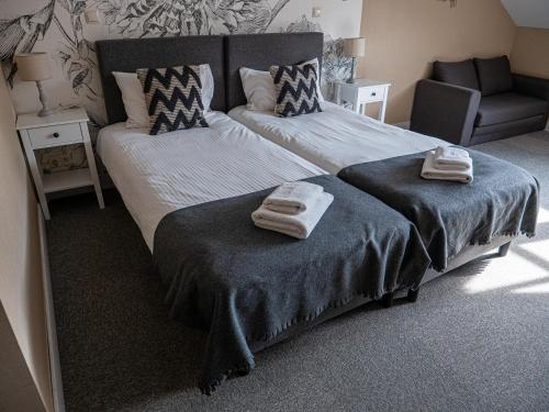a bedroom with two beds with towels on them at Wierzbowe Ranczo - blisko Suntago in Budy Michałowskie