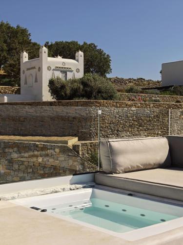 a hot tub on the roof of a house at Mykonos Earth Suites in Mýkonos City