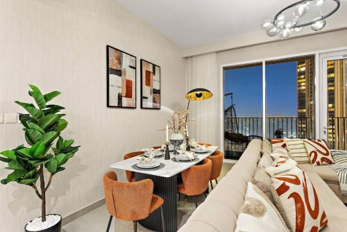 a living room with a couch and a table at Chic 2BR Stay at Creek Horizon with Pool, Gym and Prime Dubai Location in Dubai