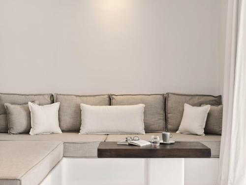 a living room with a couch with a table at Mykonos Earth Suites in Mýkonos City