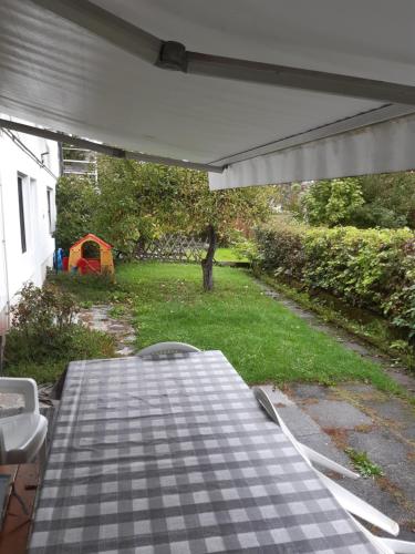 a table and chairs on a patio with a tent at Apartments Rainbow in Pörtschach am Wörthersee