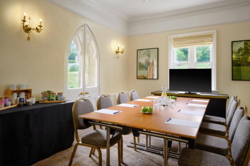 a conference room with a wooden table and chairs at Delta Hotels by Marriott Breadsall Priory Country Club in Derby