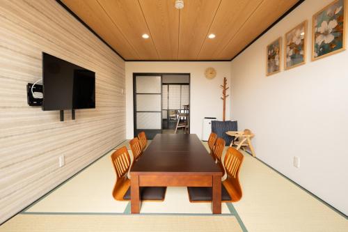 a dining room with a table and chairs at JPRESERVE Bishamoncho in Kyoto