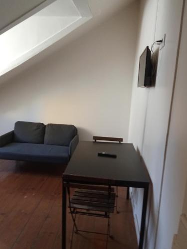 a living room with a blue couch and a table at Amoreiras Lisbon Apartments in Lisbon