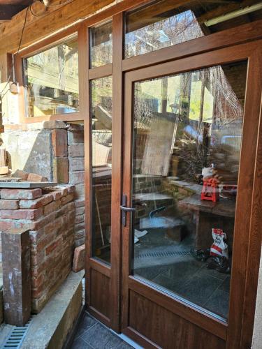 an open glass door with a view of a patio at Vila Ema-kuća za odmor in Ludbreg